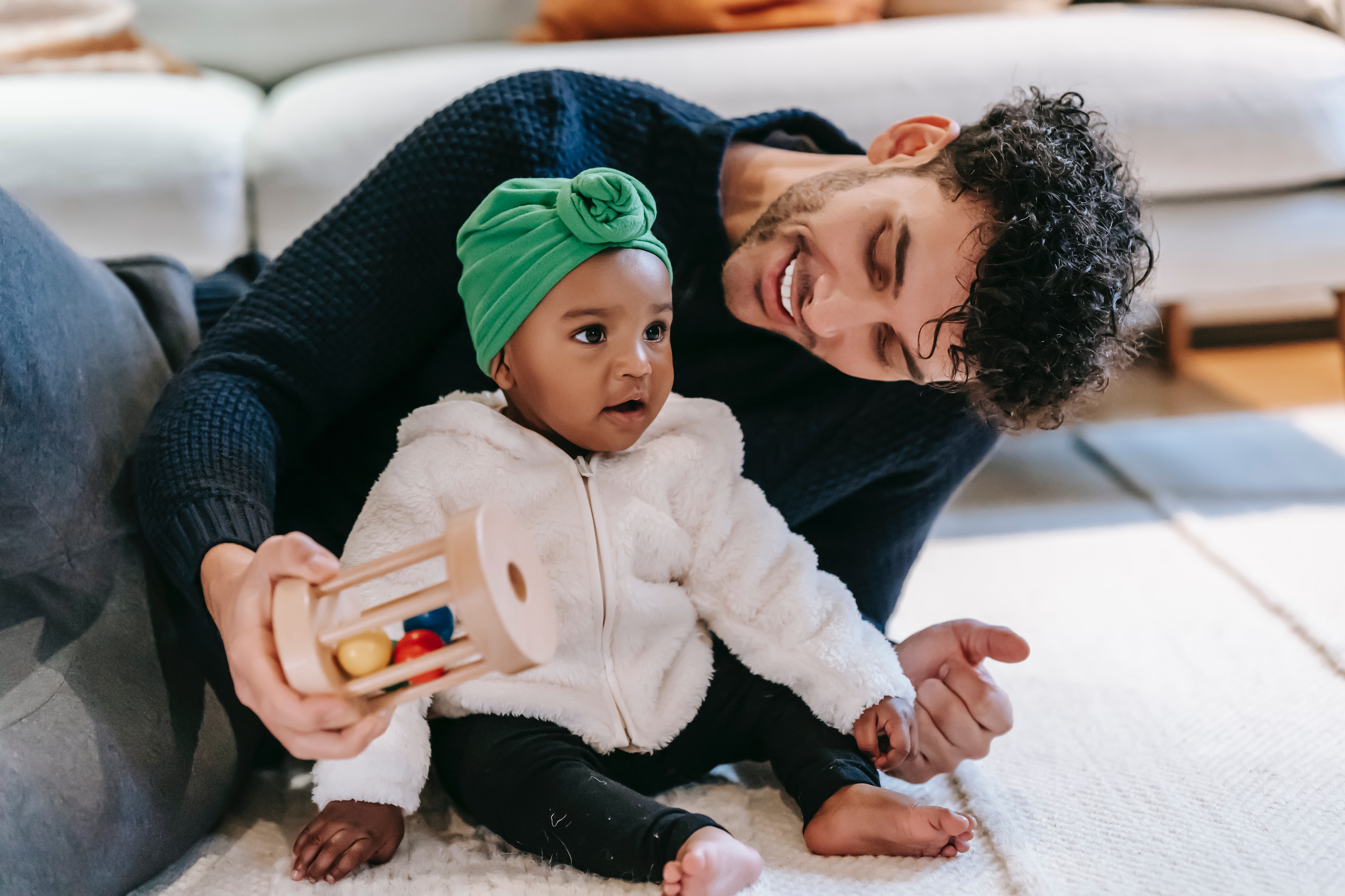 Photo by William  Fortunato : https://www.pexels.com/photo/smiling-father-playing-with-indian-baby-girl-at-home-6392805/